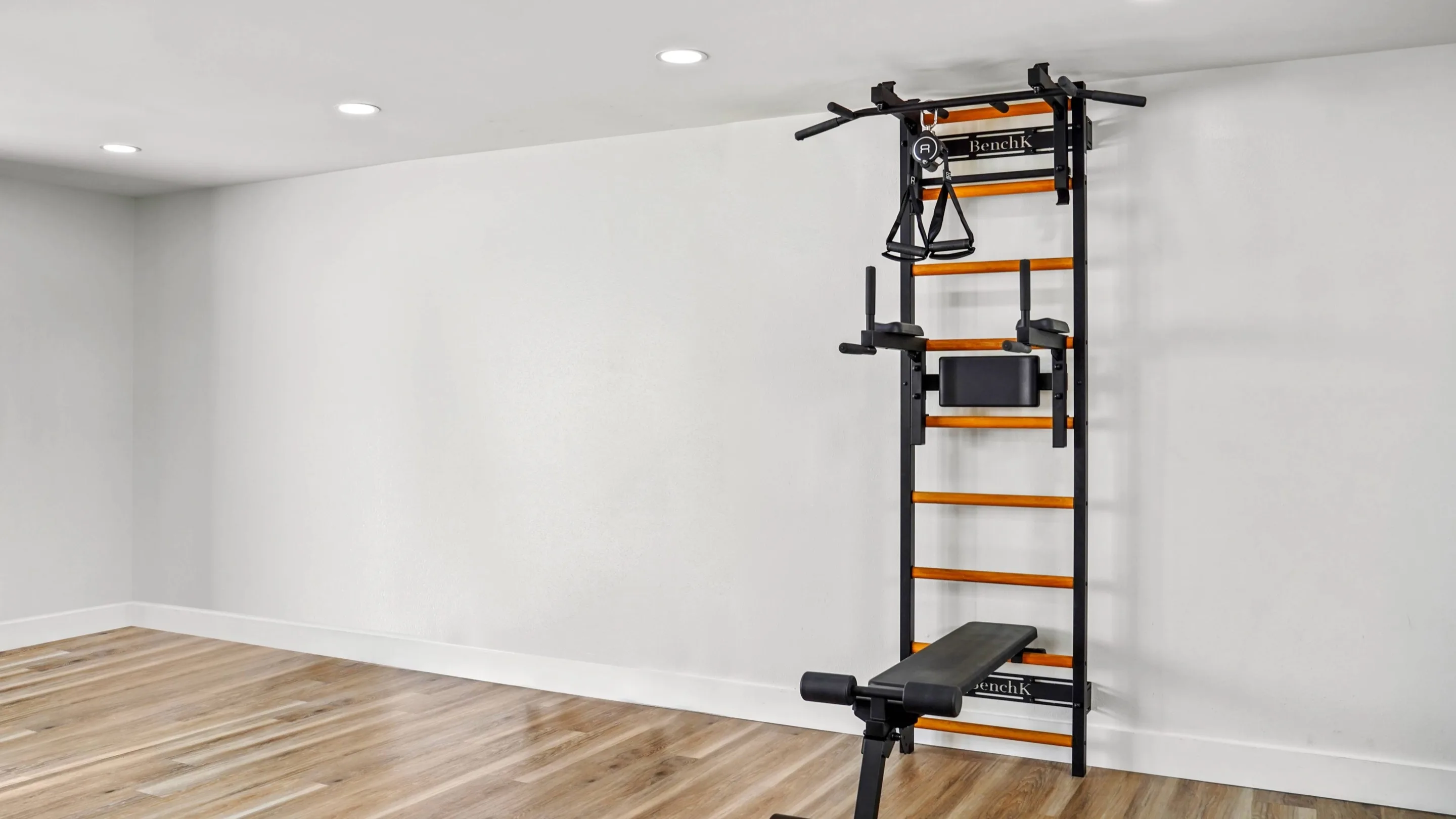 BenchK wall bar with ladder, pull-up bar, dip station, and bench installed